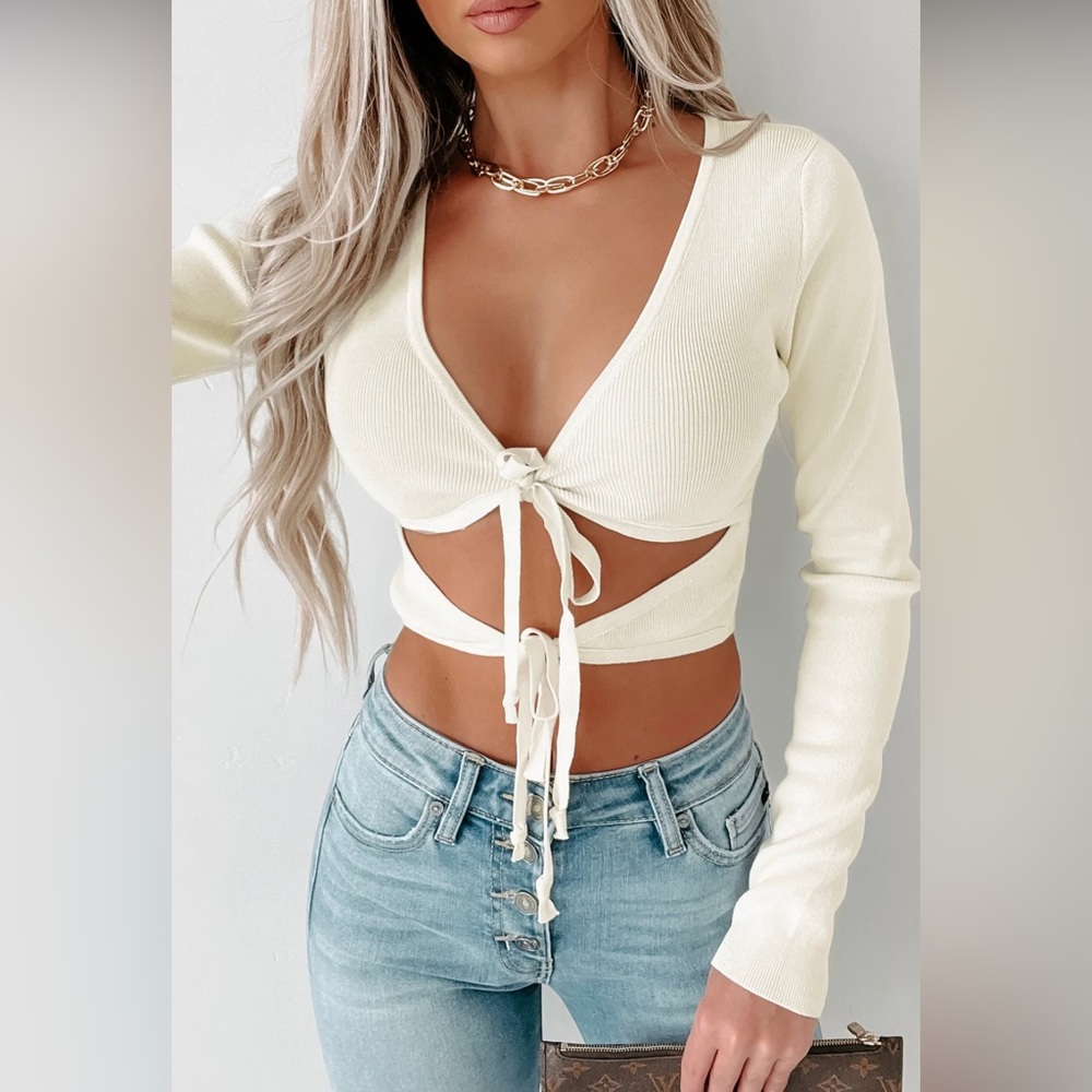 Cream light weight long sleeve wrap around crop top.
